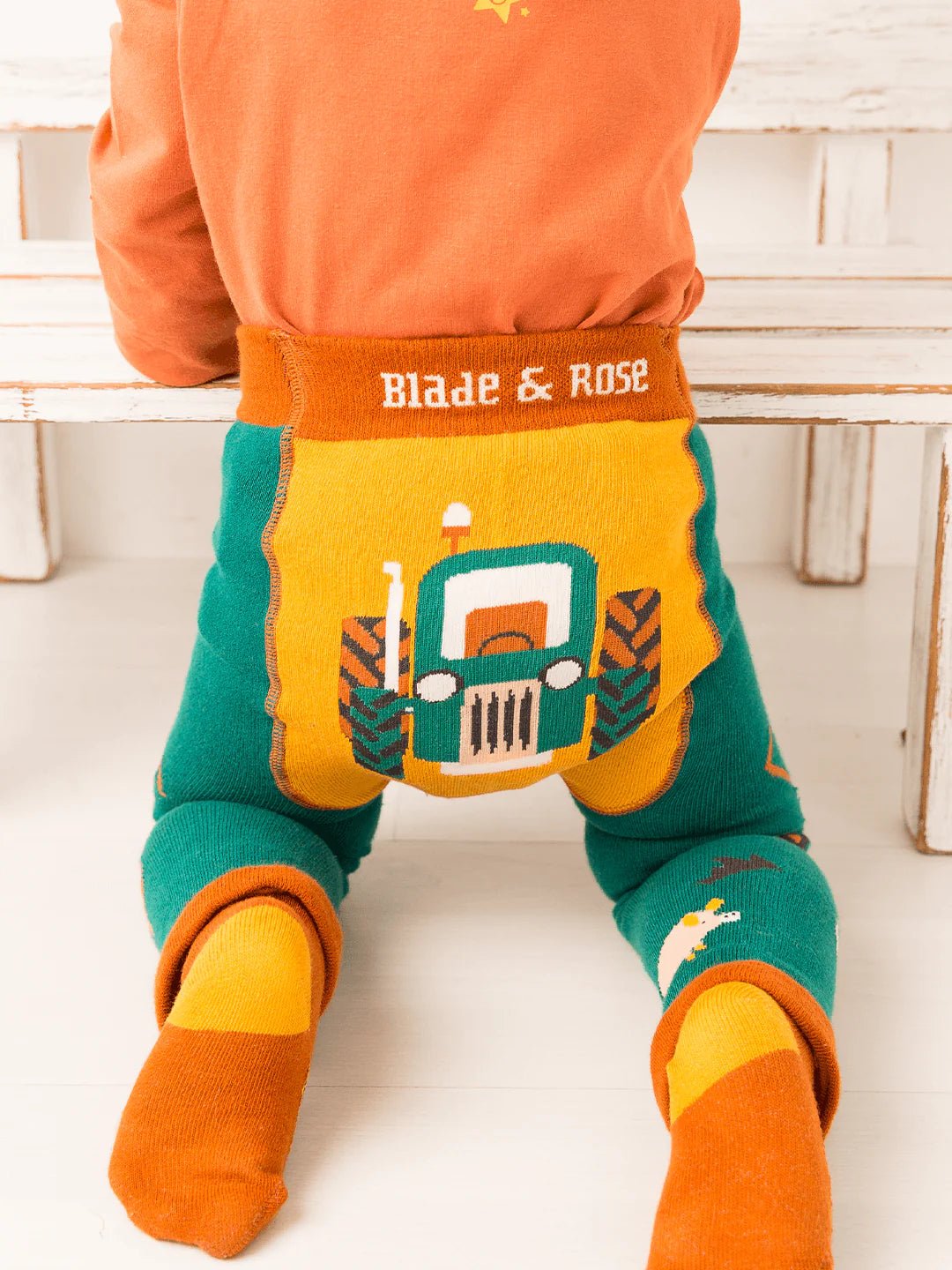 Children's colorful pants with a tractor design and 'Blade & Rose' branding on a white background.