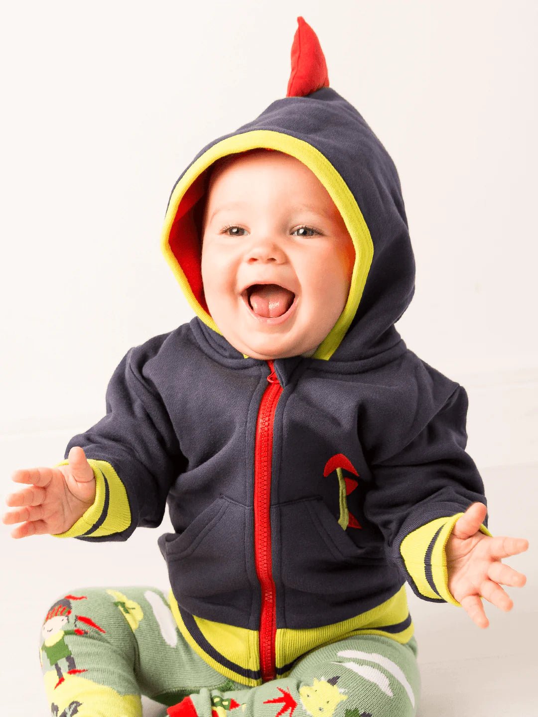 Baby wearing a colorful hoodie with a red zipper and yellow accents on a white background