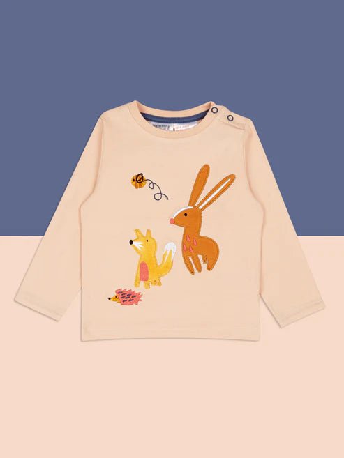 Beige long-sleeve shirt with animal illustrations on a blue and beige background