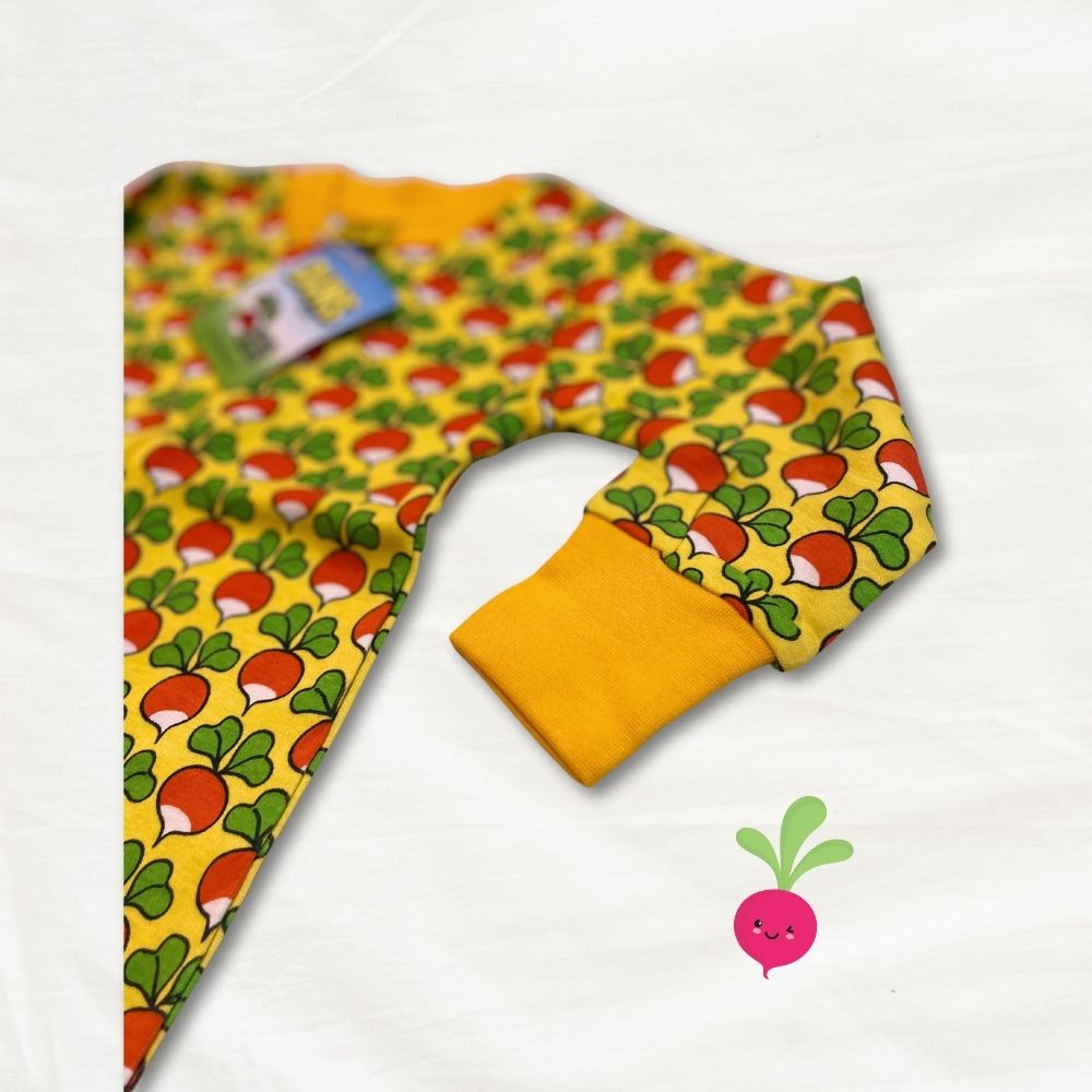 Colorful baby onesie with a radish pattern of red and green shapes on a white background