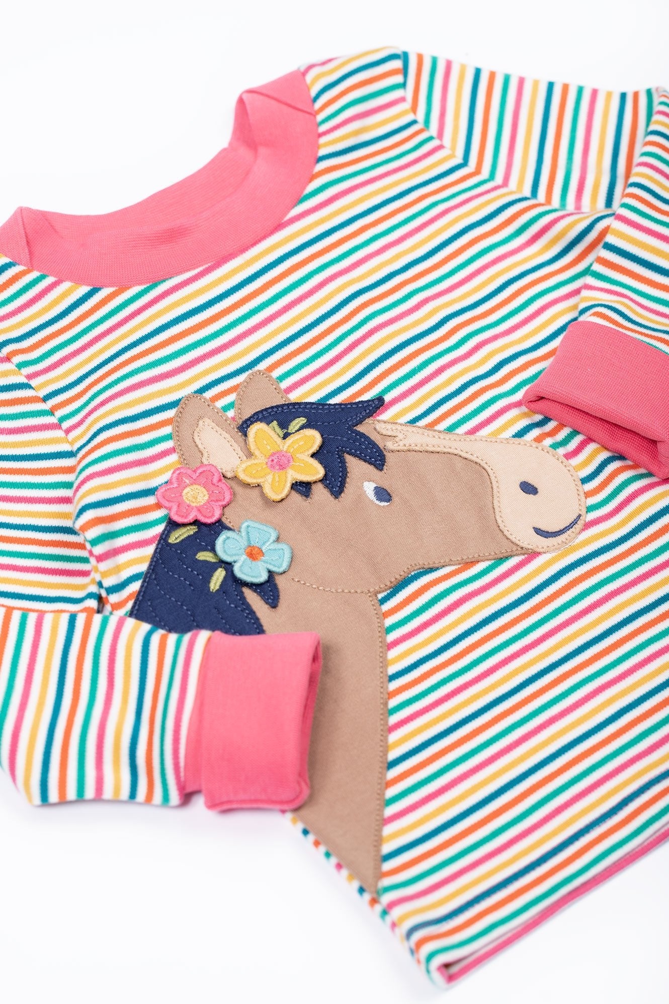 Colorful striped poncho with a horse design on a white background