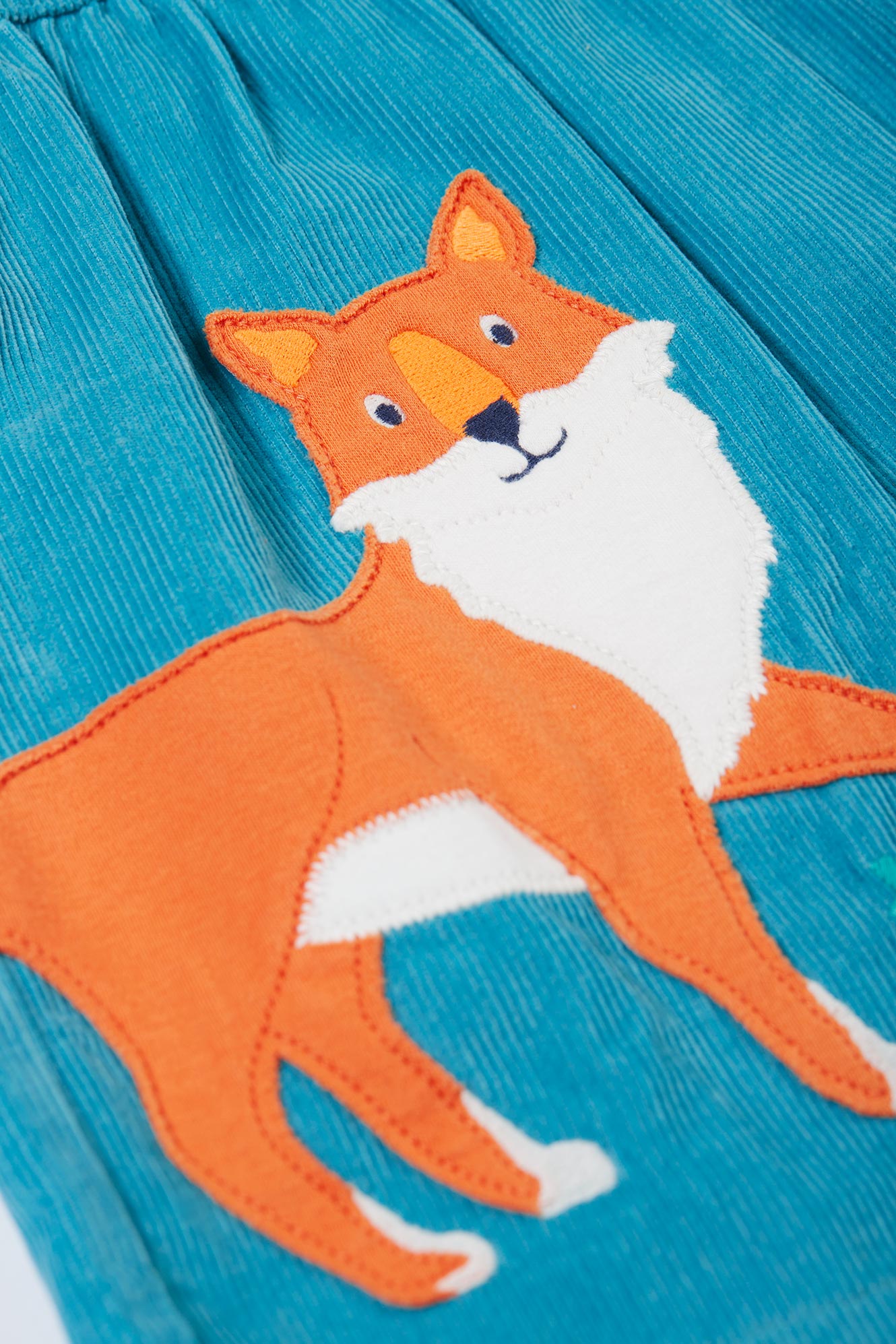 Orange fox patch on a blue fabric background