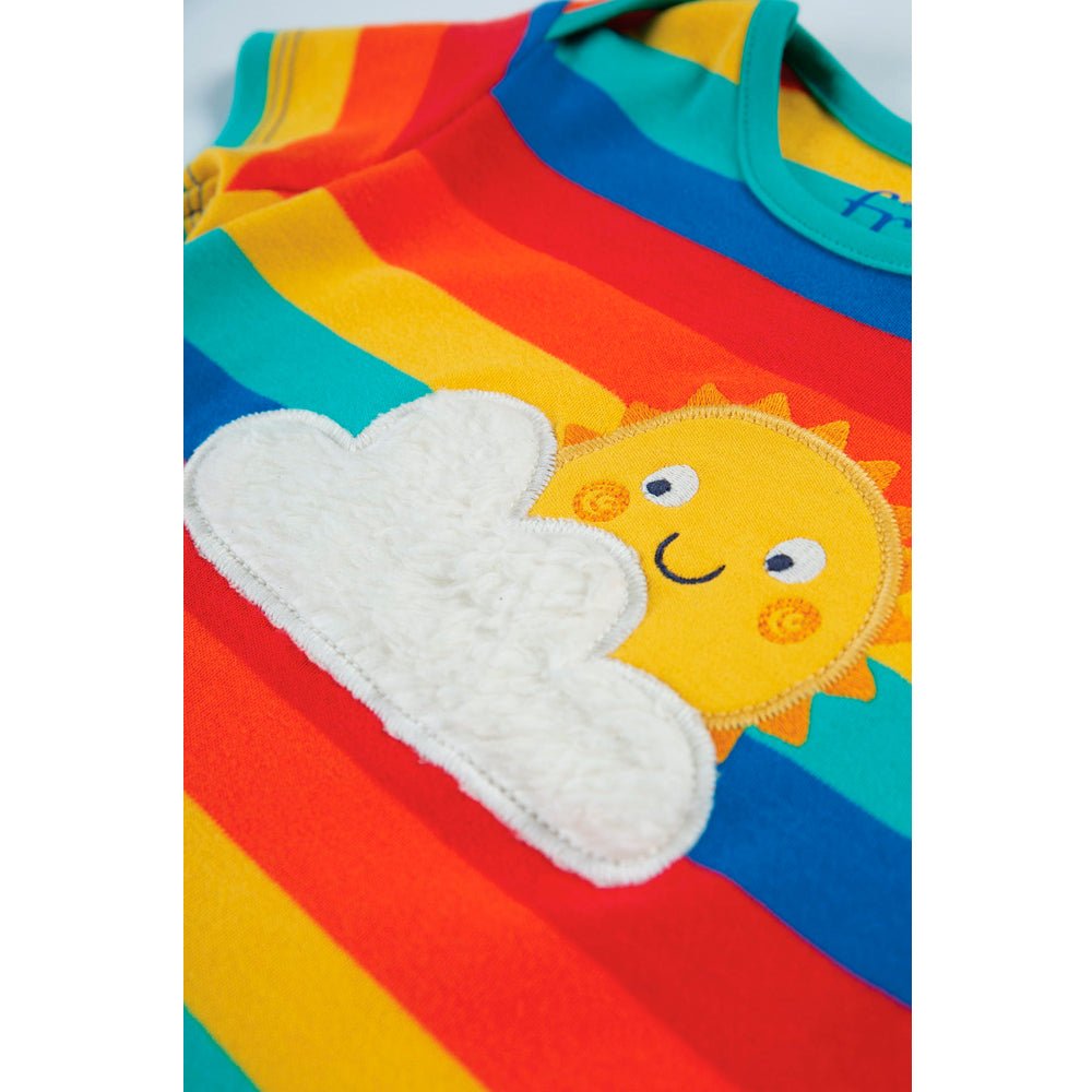 Colorful children's outfit with a sun and cloud design on a white background