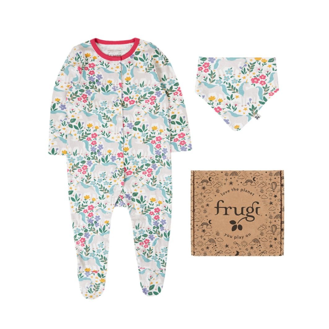 Floral-patterned baby onesie with matching hat and 'frugi' branded box on a white background