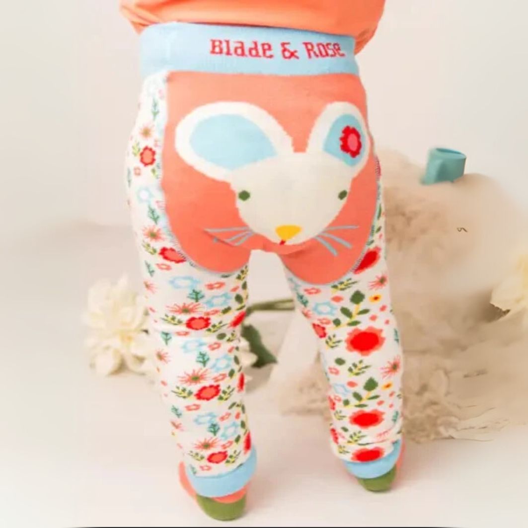 Children's leggings with a cartoon mouse design and floral pattern on a white background.