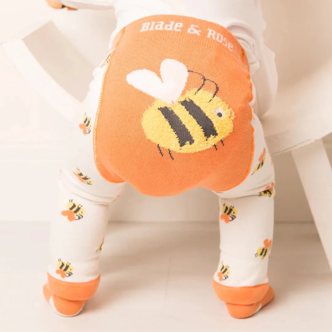 Child wearing a onesie with a bee design and 'Blade & Rose' branding.