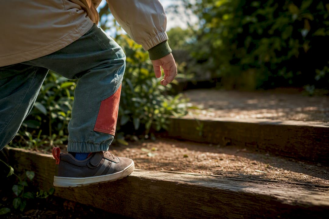 Child wearing durable clothes while playing