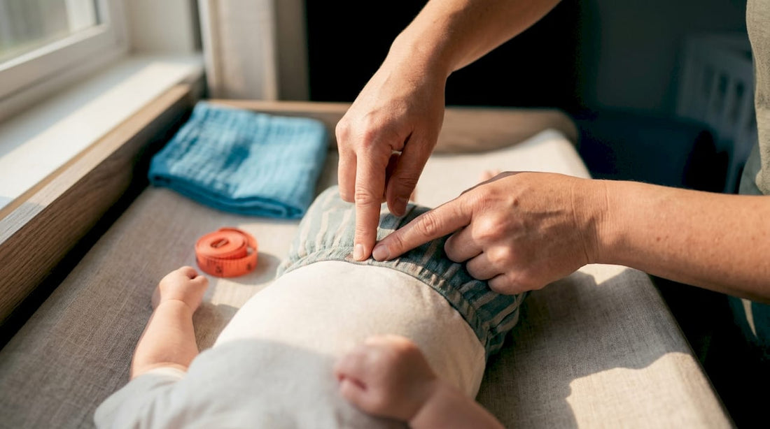 Caregiver checking baby garment waistband fit