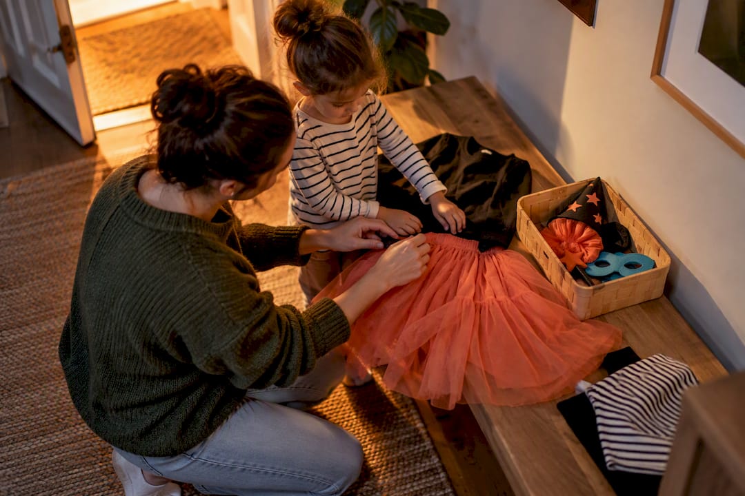 Parent and child arranging DIY costume clothes