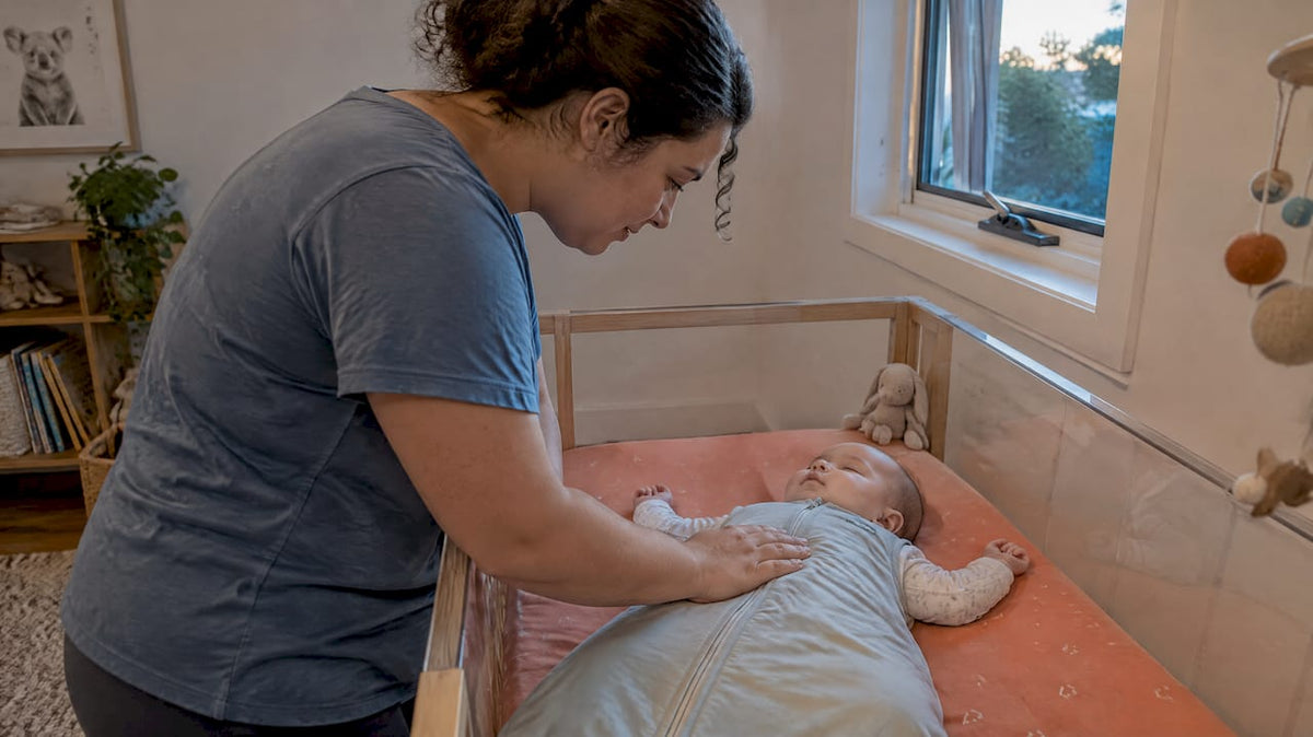 Parent checking baby’s layered sleep clothing