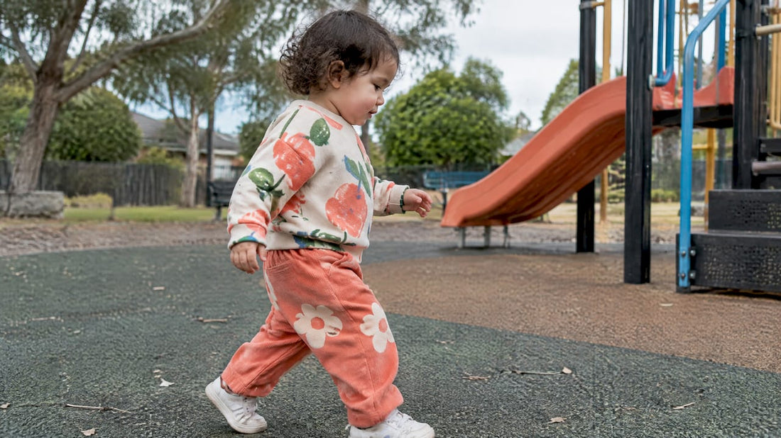 Toddler moving in colorful printed kidswear