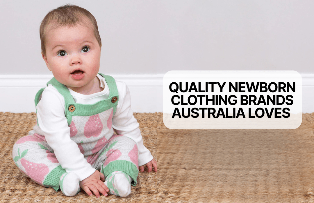 Baby sitting on woven rug wearing pink and green strawberry print newborn clothing, text on right