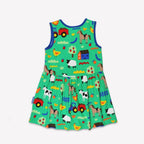 Green sleeveless children's dress with colorful farm animal and tractor print