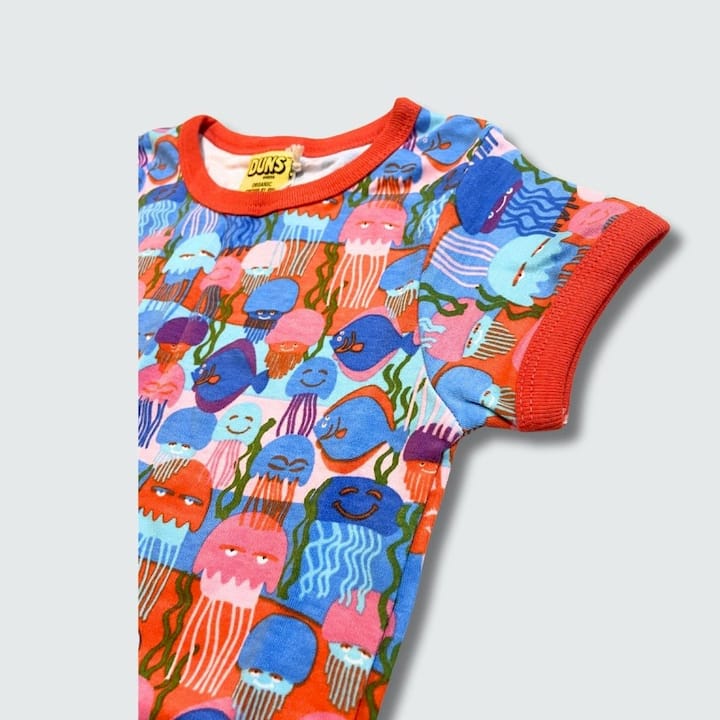 Colorful children's onesie with jellyfish pattern on a light gray background