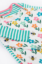 Floral and striped fabric with bees and flowers on a white background