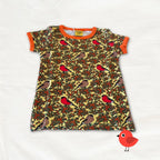 Children's dress with bird and berry pattern on a white background