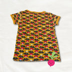 Yellow dress with red and black pattern on a white background