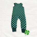 Green and blue patterned baby romper on a white background with a shamrock icon.