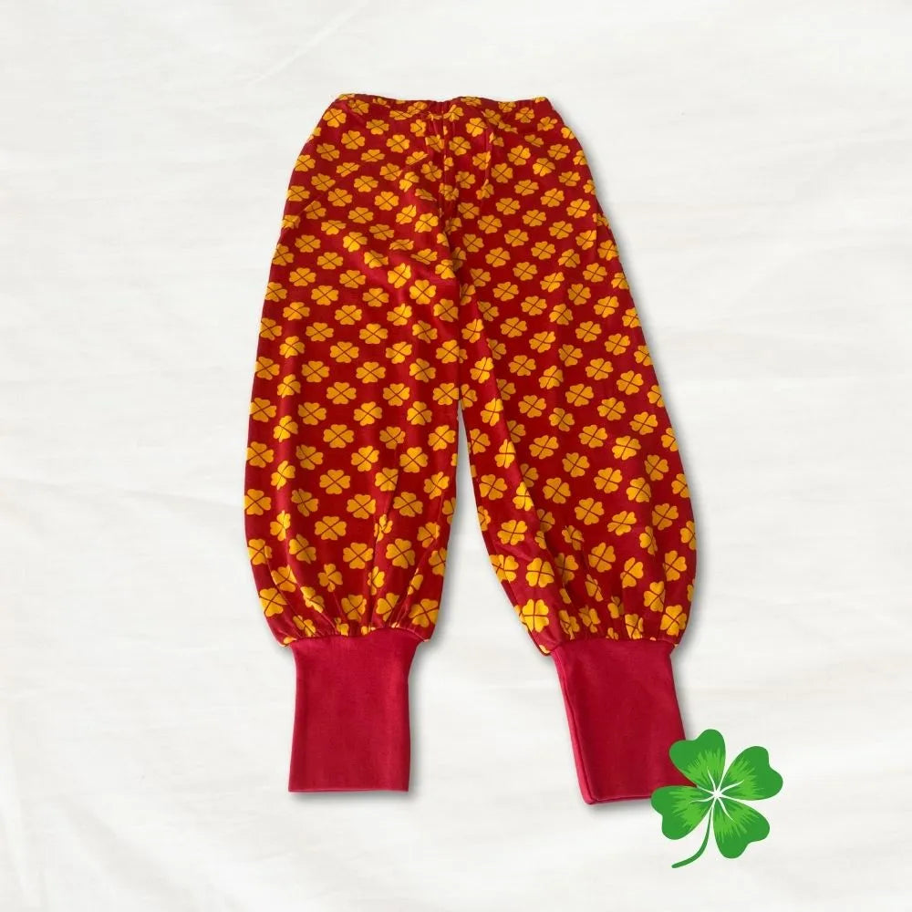 Red pants with yellow floral pattern on a white background
