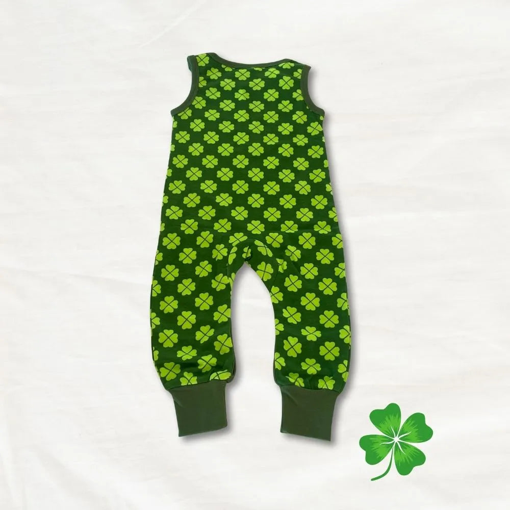 Green baby romper with clover pattern on a white background