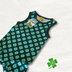 Green baby romper with four-leaf clover pattern on a white background