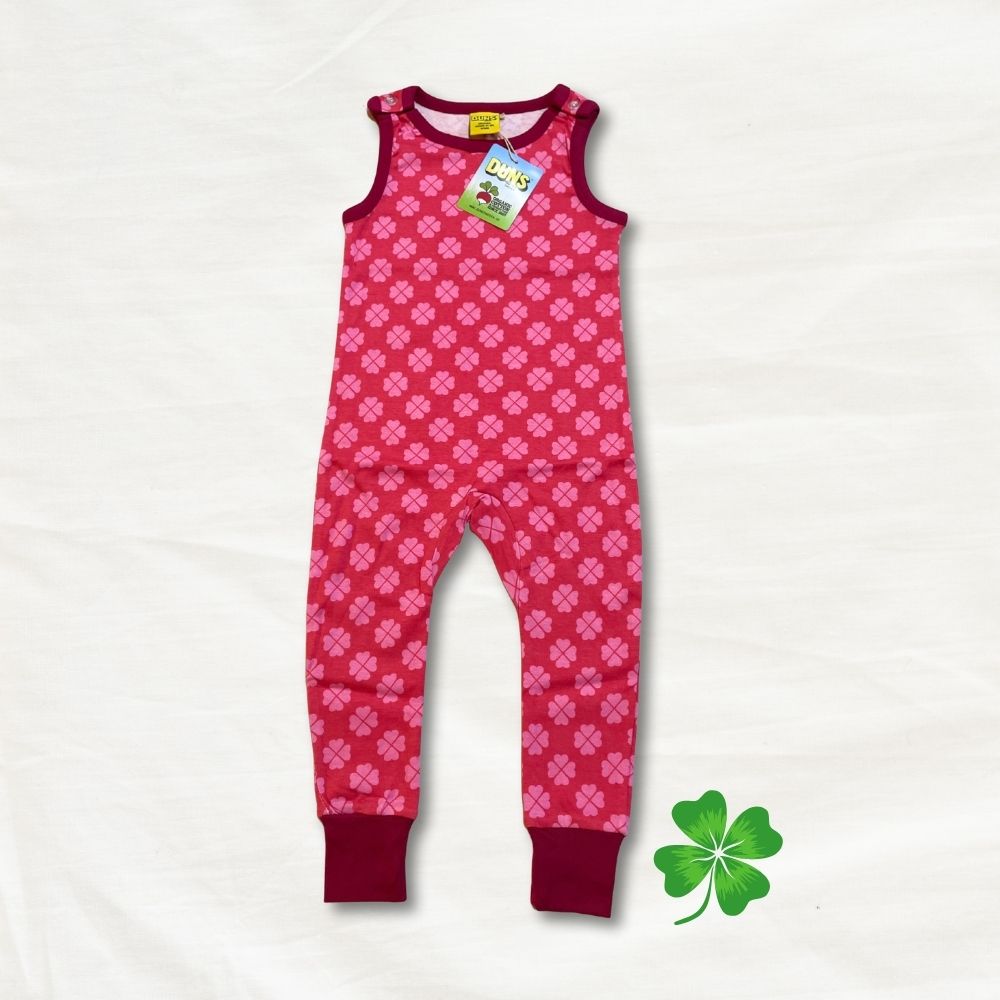 Pink children's onesie with a clover pattern on a white background