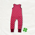 Pink patterned clover onesie on a white background with a green leaf logo.