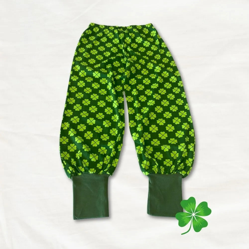 Green baby leggings with clover pattern on a white background