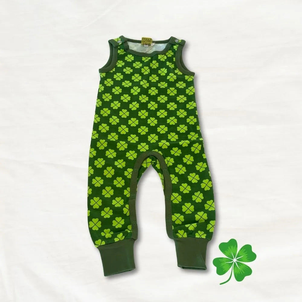 Green baby romper with clover pattern on a white background