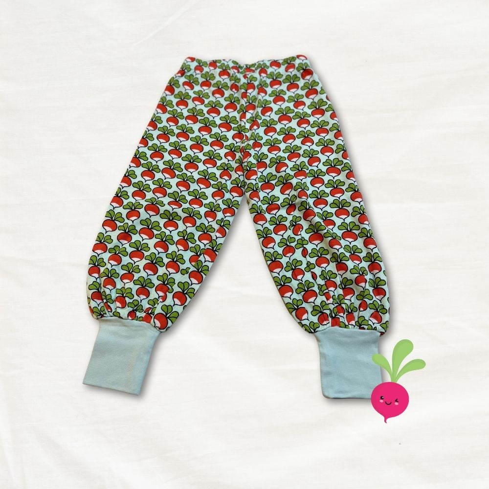 Children's pants with radish pattern on a white background