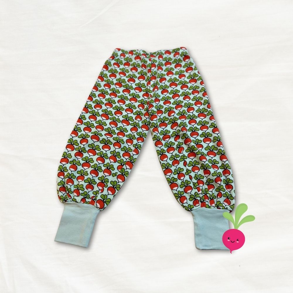 Children's pants with radish pattern on a white background