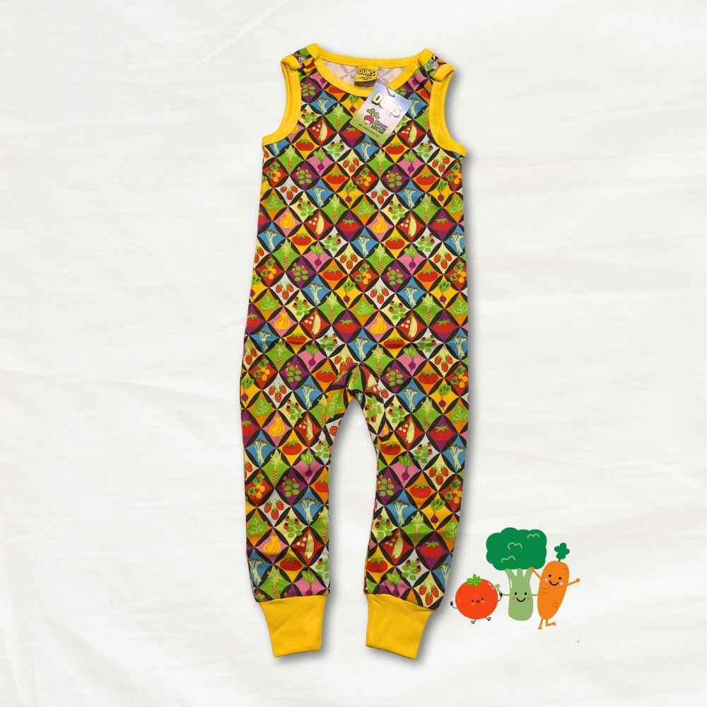 Colorful patterned onesie with yellow trim on a white background