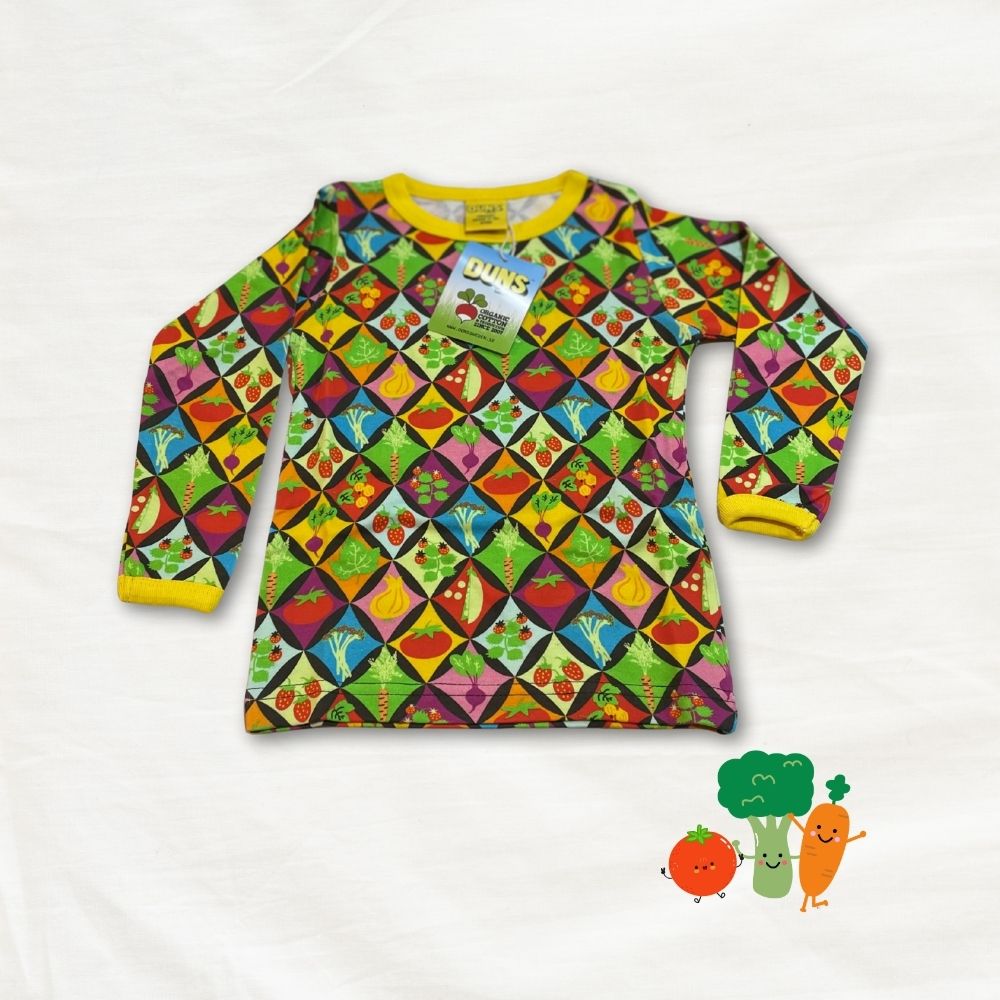 Colorful children's long-sleeve shirt with vegetable pattern on a white background