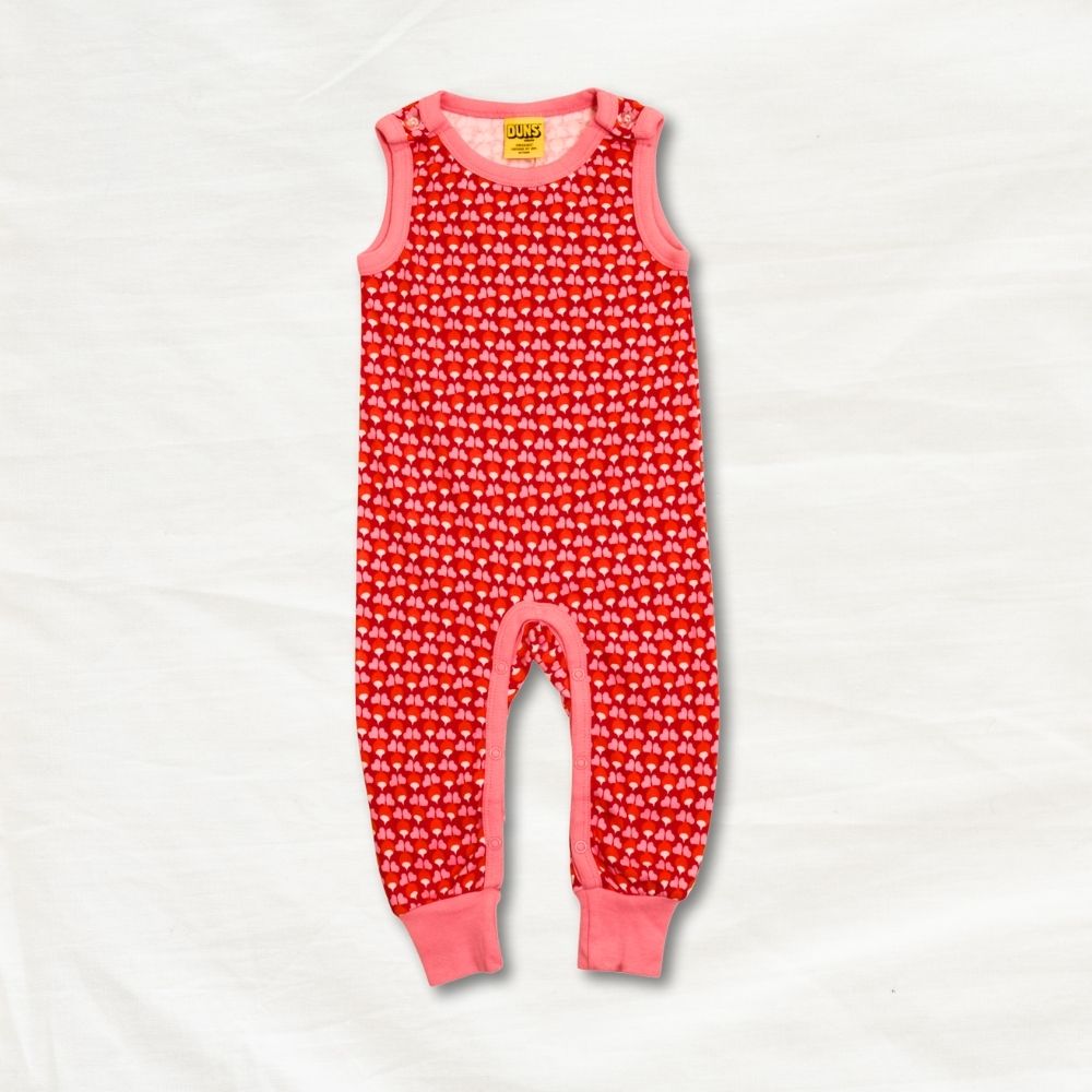 Red children's dungarees with pink accents on a white background