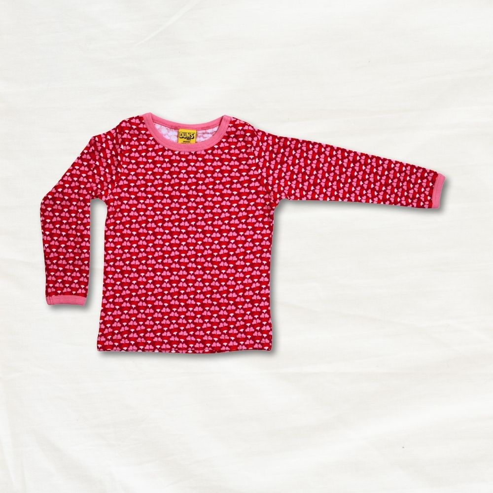 Red long-sleeve shirt with a pattern on a light gray background
