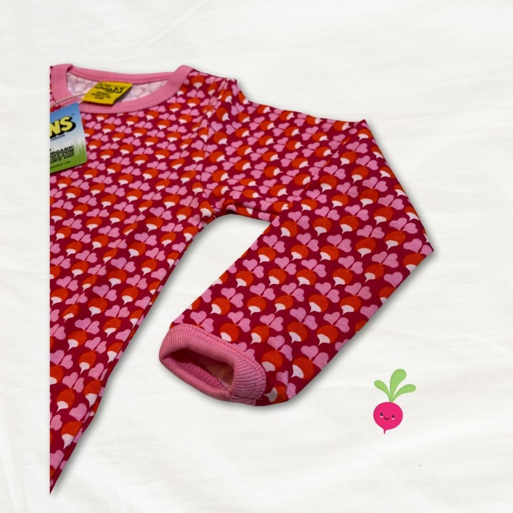 Pink children's top with radish pattern on a white background