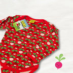 Red baby onesie with green and pink pattern on a white background