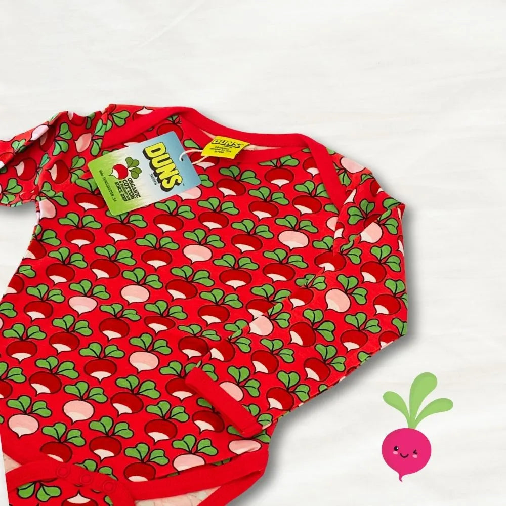 Red baby onesie with green and pink pattern on a white background