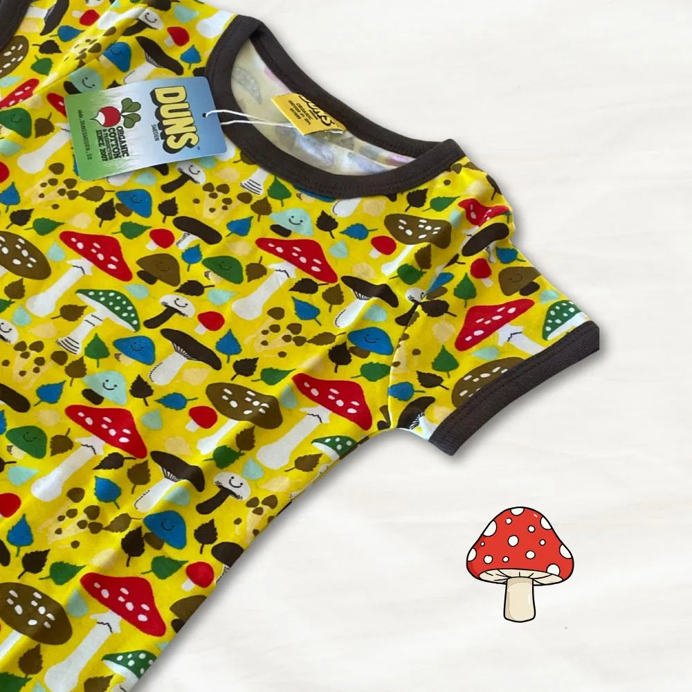 Yellow baby romper with mushroom pattern on a white background