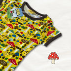 Yellow baby romper with mushroom pattern on a white background