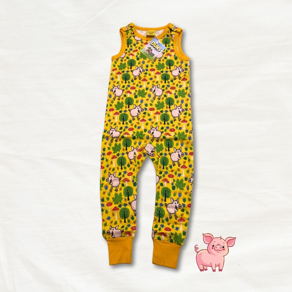 Yellow children's romper with pig pattern on a white background