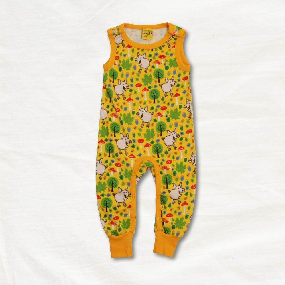 Yellow children's romper with pig pattern on a white background
