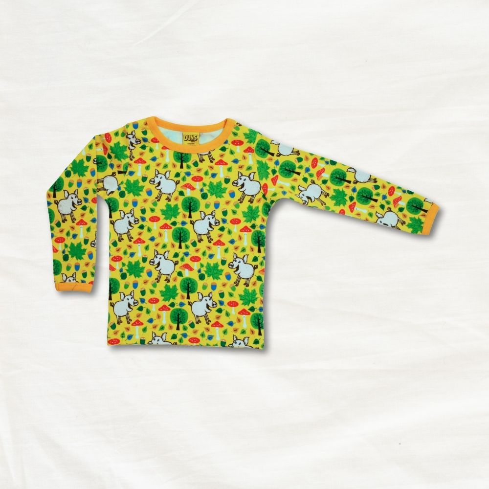 Children's long-sleeve shirt with pig and nature pattern on a white background