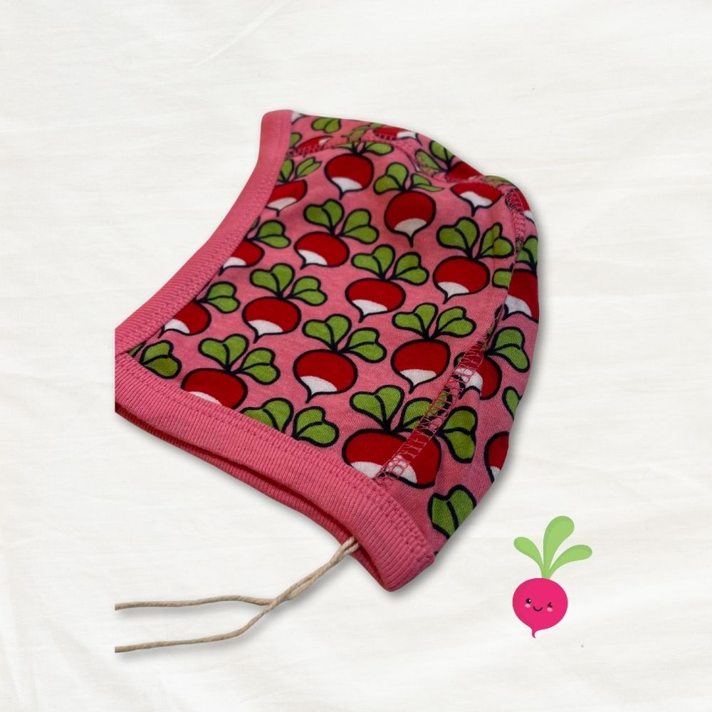 Pink baby hat with radish pattern on a white background