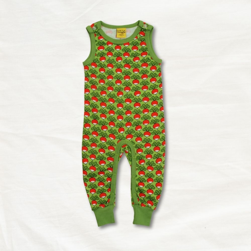 Green children's onesie with radishpattern on a white background