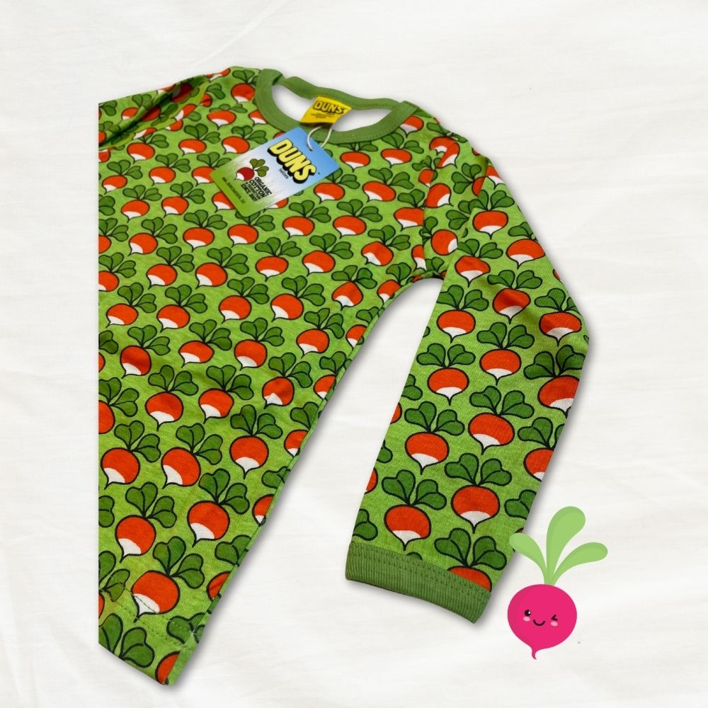 Green children's top with red and white radish pattern on a white background