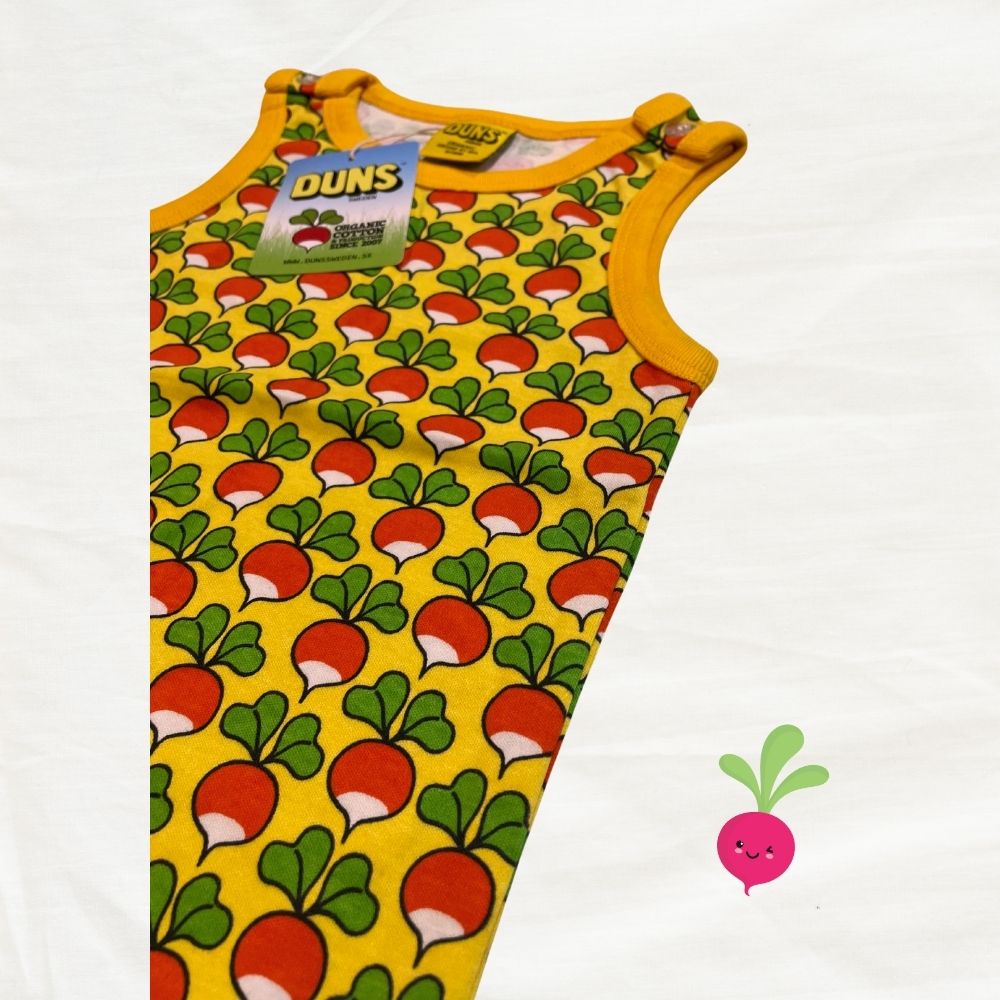 Yellow sleeveless dungarees with radish pattern on a white background