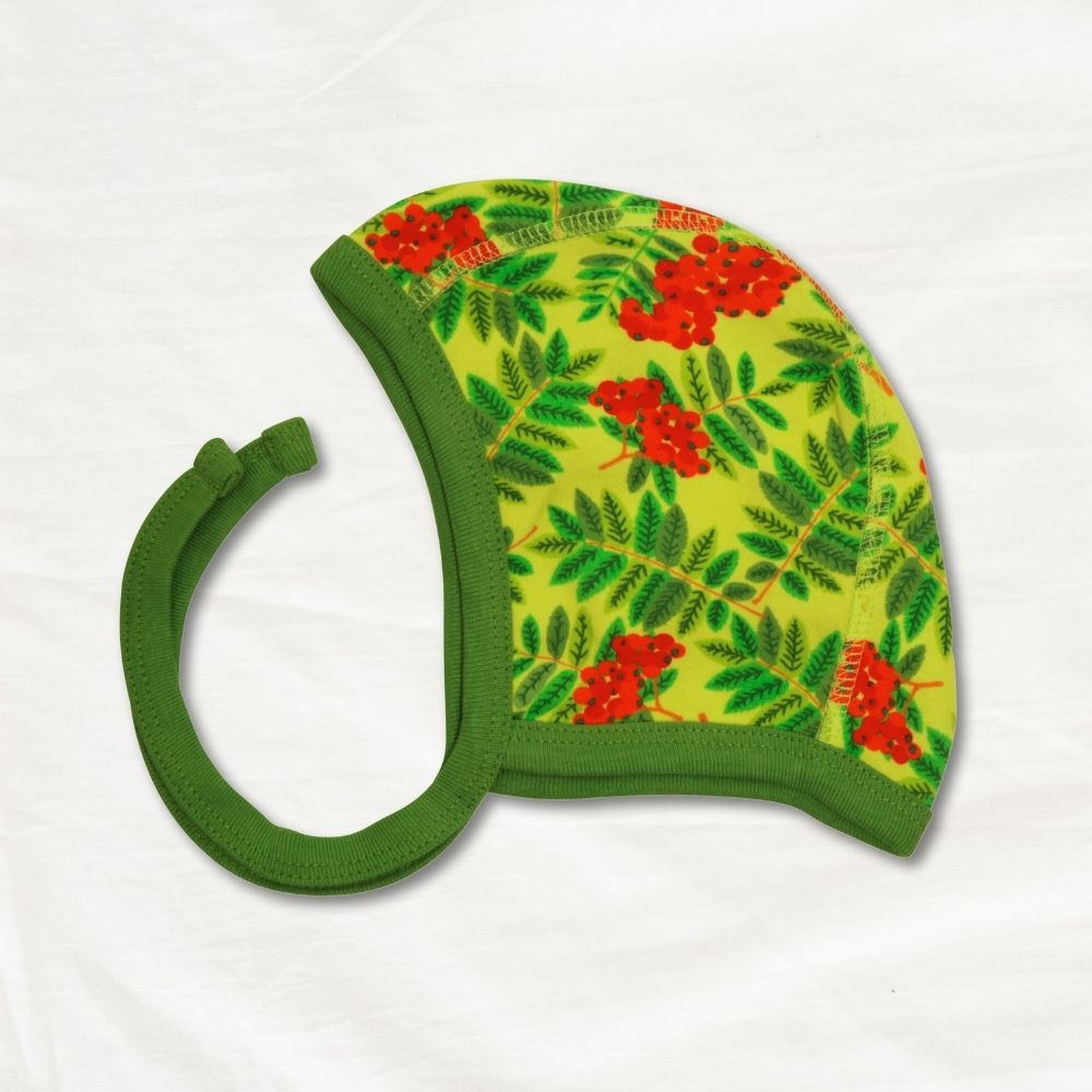 Green baby hat with red floral pattern on a white background