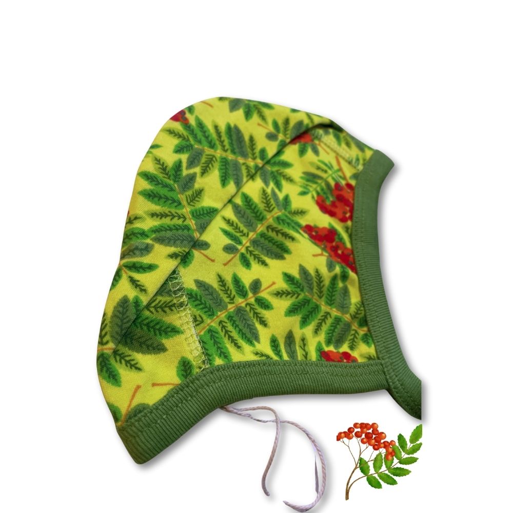 Green baby hat with leaf pattern on a white background