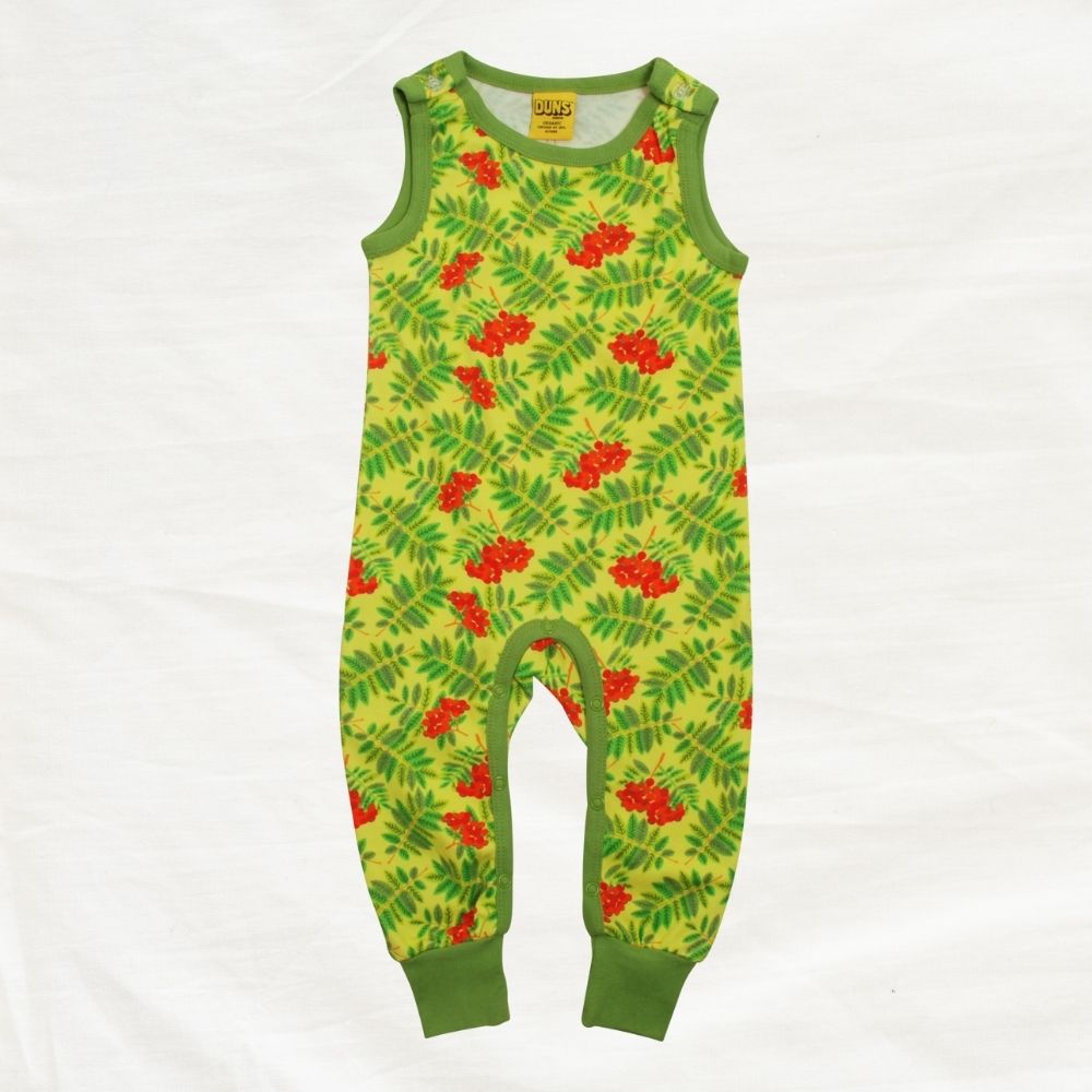 Green children's romper with red floral pattern on a white background